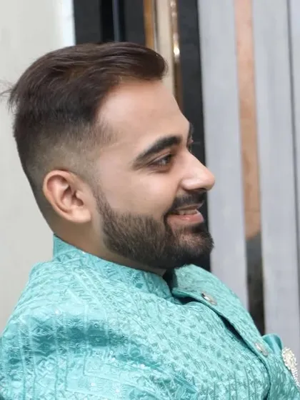 A side profile showing the groom's sharp haircut and clean-shaven look. I provide complete grooming services, including hairstyling.