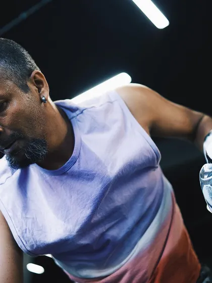 A fighter, drenched in sweat, shows the effort and determination required in our training sessions.