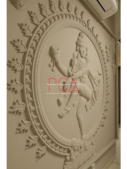 An angled, detailed view of the Nataraja mural, highlighting the three-dimensional quality of the carving.