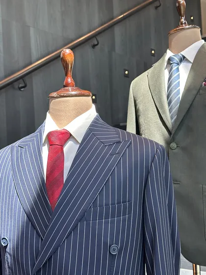 A display of our finished garments at the BCG trunk show. From a classic pinstripe double-breasted suit to a modern olive green jacket, we showcased the range of what's possible with bespoke.