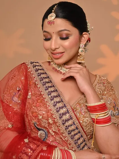 A close-up of the "Golden Era" lehenga, showing the delicate peacock embroidery on the dupatta and the rich texture of the fabric. Every detail is crafted to make you feel special.