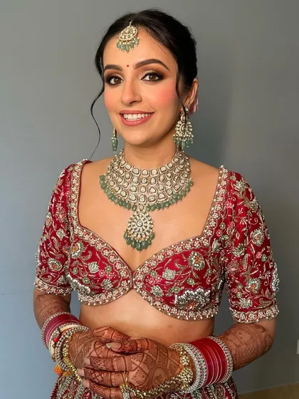 A close-up of the bride's makeup, featuring a soft smokey eye and a flawless base that enhances her natural beauty.