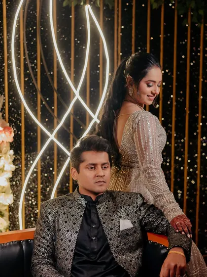 A regal portrait of the couple at their reception. The bride's pastel lehenga and high ponytail create a chic and modern look.