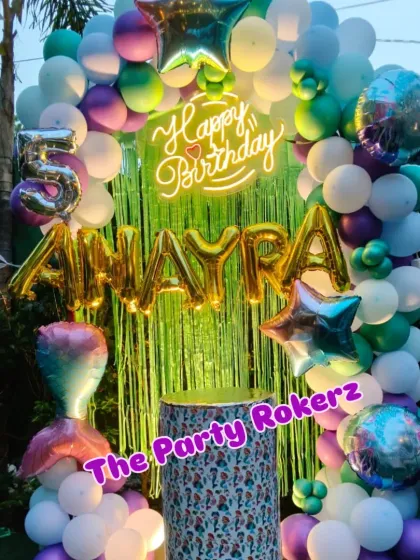 A different angle of the Mermaid-themed 5th birthday, showing the silver marquee number and the full balloon arch.