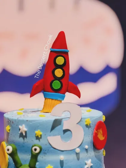 The fondant rocket ship topper, ready for blast-off from the top of the space-themed birthday cake.