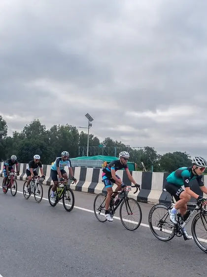 The peloton from a distance, showing the race unfolding against a wide, open landscape.