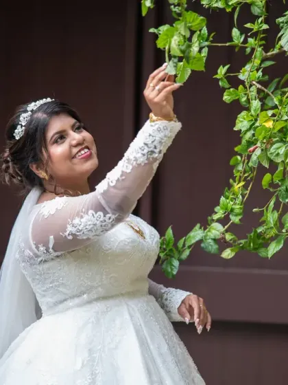 A sweet, candid moment of the bride interacting with nature. These unposed shots often have the most charm and personality.