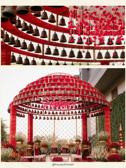 A close-up of the tiered bell structure of the mandap, showcasing the craftsmanship and the dramatic effect of hundreds of bells against the vibrant red frame.
