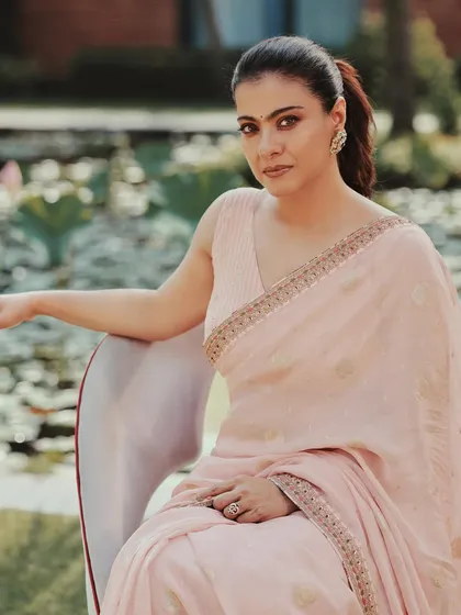 Kajol looking serene in a soft pink saree with delicate embroidery, styled for promotional events in Kolkata.