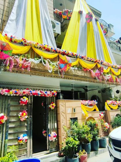 A wider view of the yellow and white themed house decoration, showing how it brightens up the entire building.