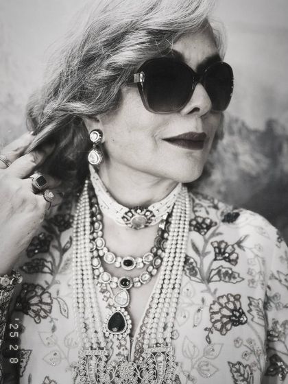 A timeless black and white photo of Zeenat Aman. This shot beautifully highlights the texture and detail of the layered necklaces and her iconic, cool demeanor.
