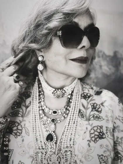 A timeless black and white photo of Zeenat Aman. This shot beautifully highlights the texture and detail of the layered necklaces and her iconic, cool demeanor.