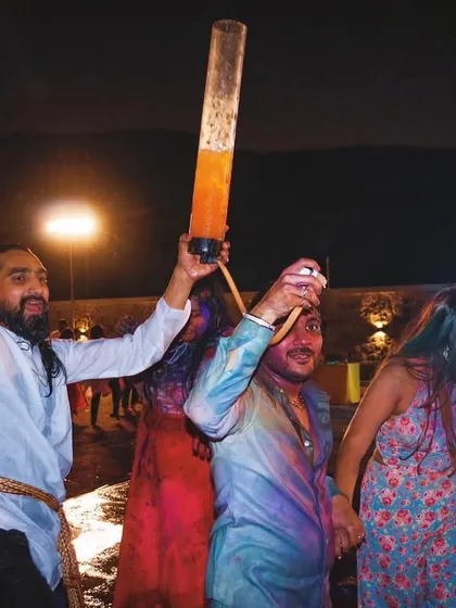 Dancing through the colors of joy at a Holi party. We bring the energy and the drinks, using fun props like this colorful smoke to amplify the festive atmosphere.