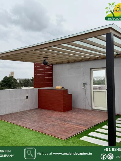 A look at a modern rooftop pergola we installed for a villa at Assetz Soul & Soil. The design combines a sleek metal frame, a glass roof for rain protection, a warm wooden deck for the seating area, and a custom-built bar counter for entertaining.