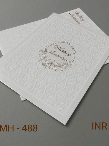 This budget-friendly white invitation has a wavy embossed pattern and a simple floral nameplate. It's a great choice for an elegant look without the high cost.