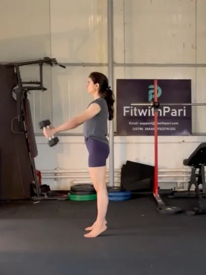 Calf raises with dumbbells. Even simple moves like this are done with Pilates principles in mind: focus, control, and breath.