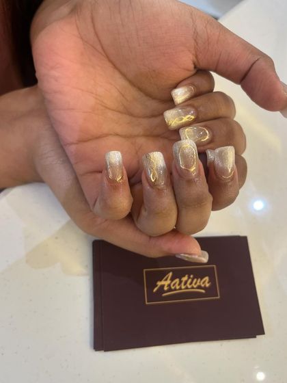 A close-up of the gold and white cat eye design, showing the Aativa branding. We pay attention to every detail.