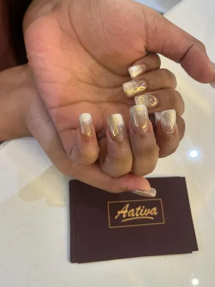 A close-up of the gold and white cat eye design, showing the Aativa branding. We pay attention to every detail.