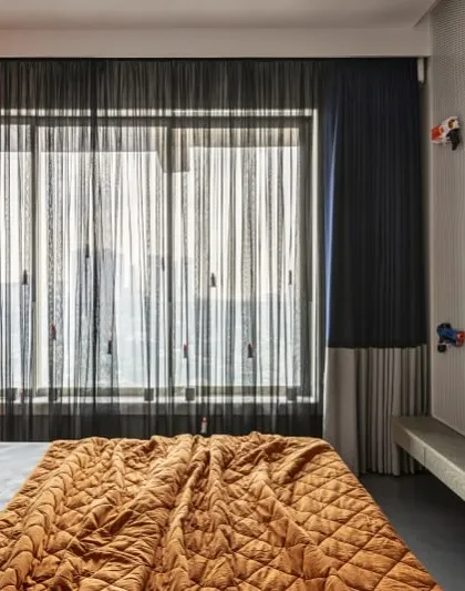 This son's bedroom in a Mumbai penthouse is inspired by the thrill of Nerf battles. I blended fun, functionality, and finesse with playful pops of color and smart storage solutions for a youthful yet luxurious edge.