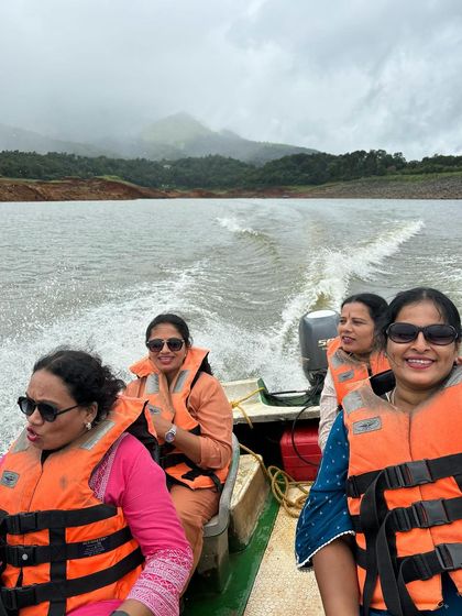 A group enjoying a boat ride on the Banasura Sagar Dam in Wayanad.