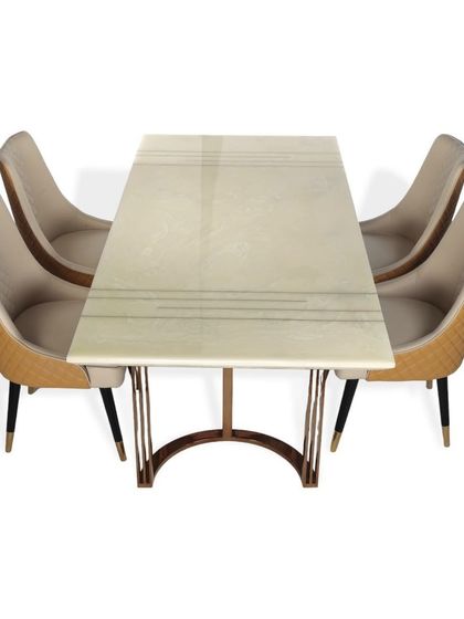 An overhead view of the dining set, highlighting the quilted leatherette on the back of the chairs and the clean lines of the marble tabletop. The design ensures both comfort and style.