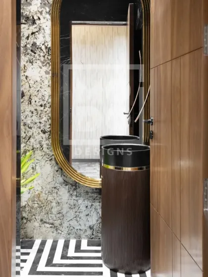 Our powder washroom designs transform everyday routines into moments of luxury. This space features dramatic marble, a unique pedestal sink, and geometric floor tiles for a bold statement.