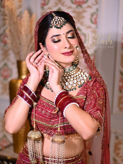 The joy of creating something beautiful. This student is putting the final touches on her bridal model, showcasing the skills learned in our professional course.