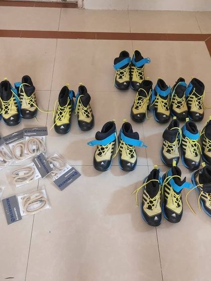 The full set of donated canyoning shoes and equipment, ready to be distributed to guides in the North East.