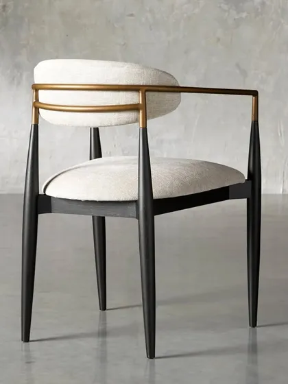 The Jagger dining armchair, with a continuous metal armrest that wraps around the back, adding to its sleek, modern aesthetic.