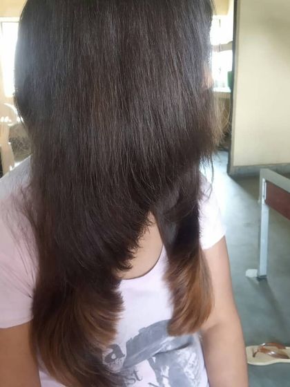 Our cosmetology course also includes the fundamentals of haircutting. This image shows a student's work on a layered haircut, demonstrating their understanding of angles and texturizing.