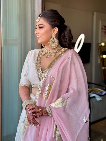 In the midst of haldi and love, my bride shines. For her Jaipur destination wedding, I created a glowing, fresh look to match her white and pink Haldi outfit.