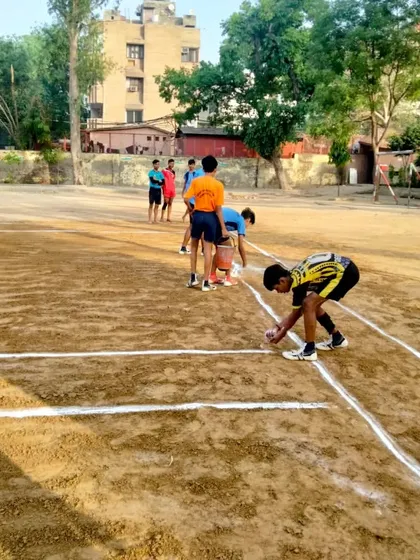 Our players preparing the kabaddi ground by drawing the lines. We teach them to respect the 'mitti' (soil) where they train and play.