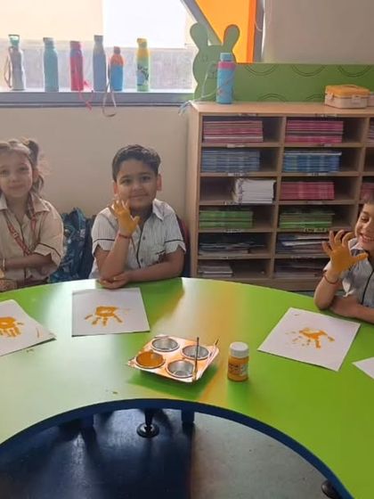A group of young boys shows off their hands painted in bright yellow, ready to create handprint art. These simple yet fun activities are a great way for our little ones to explore colors and textures.