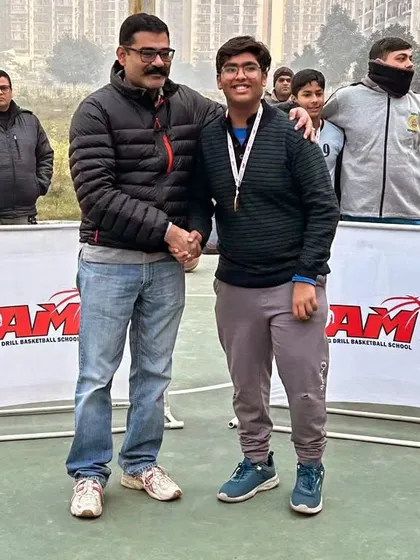 A proud parent or mentor congratulating a player on their achievement at the Winter League. Our community support is unmatched.