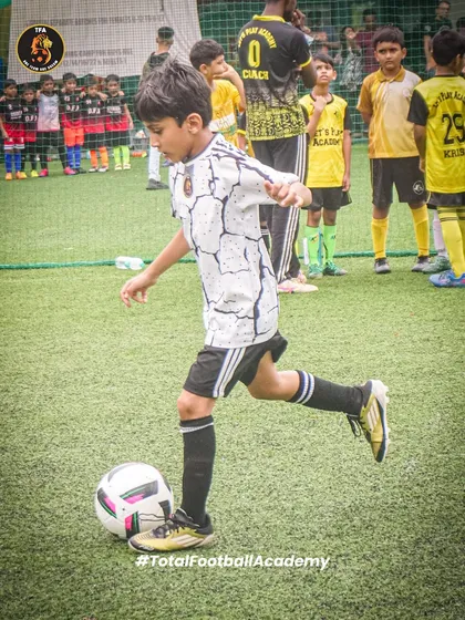 A young player demonstrating perfect technique as he prepares to strike the ball. Fundamentals are the key to success.