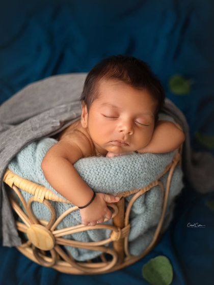 This little boy is resting his head on the edge of the basket, giving us a perfect view of his precious face. The textures of the knit blanket and basket add so much depth.