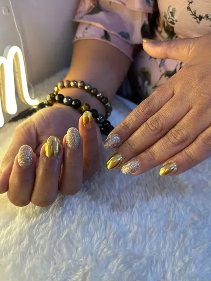 A different angle of these glamorous gold glitter and foil nails, showing how they catch the light.