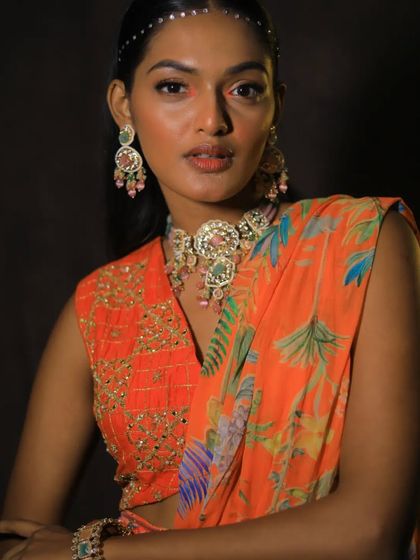 The model strikes a pose, showing how this statement choker can elevate a simple, vibrant outfit.