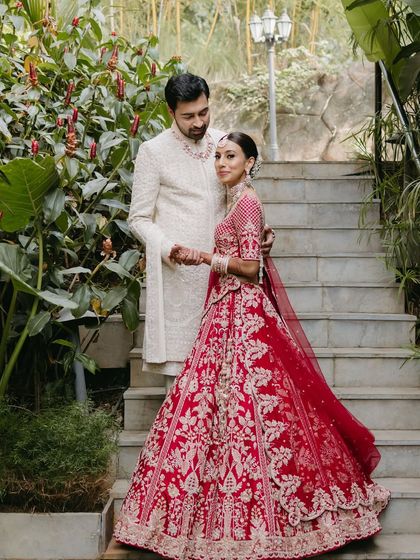 A romantic couple portrait on the stairs of the destination wedding venue. The makeup is tailored to look perfect in both natural and artificial light.