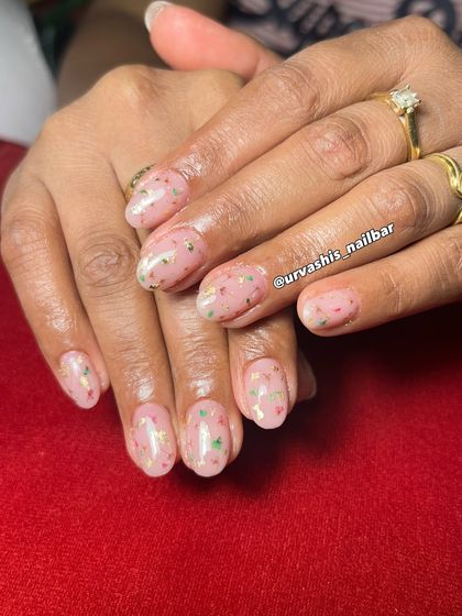 This design uses real dried flowers encapsulated in a blush-toned gel overlay with flecks of gold foil. It's a beautiful way to wear a piece of nature on your nails. The video shows a bit of the process.