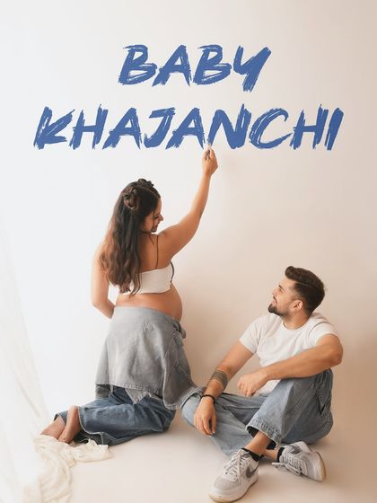 A creative shot where the couple writes their baby's name on the wall. This is a wonderful way to personalize a maternity session and announce the name.