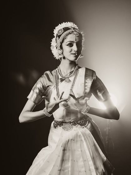 A beautiful portrait of a classical dancer. The sepia tone and soft backlighting create a nostalgic and timeless feel.