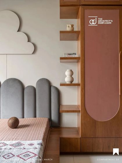For the children's room in Oatmeal House, we designed a playful and imaginative space. A cloud-shaped light fixture floats above a custom bed with a scalloped grey headboard, while integrated shelving and a warm pink accent on the wardrobe add both function and fun.