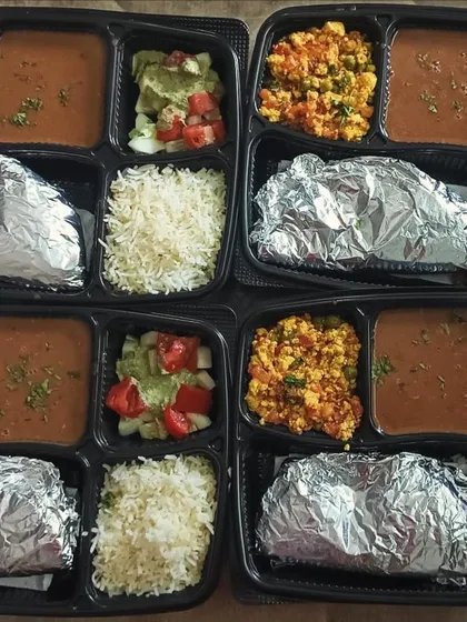 A large order of Dal Makhni and Paneer Bhurji thalis. The fresh salad with tomatoes adds a nice touch of color and freshness.
