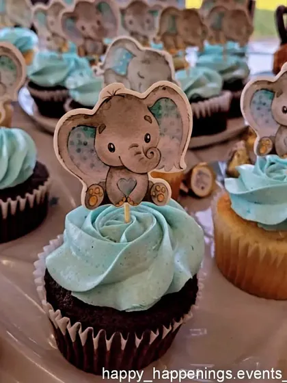 We coordinate even the smallest details, like these delightful cupcakes. Each one is topped with a cute baby elephant, ensuring the theme is carried through to the dessert table for a cohesive look.