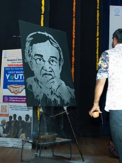 The finished live painting of the Bangalore University Vice-Chancellor on display at the event.