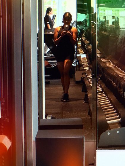 Another perspective of my workout. The rows of dumbbells in the background represent the endless possibilities for building strength.