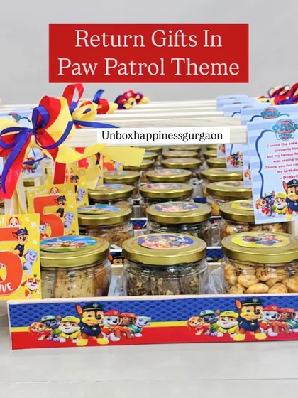 No theme is too big or small. Here's a look at a fun 'Paw Patrol' themed return gift basket, filled with jars of delicious snacks and customized with characters from the show, perfect for a 5th birthday party.