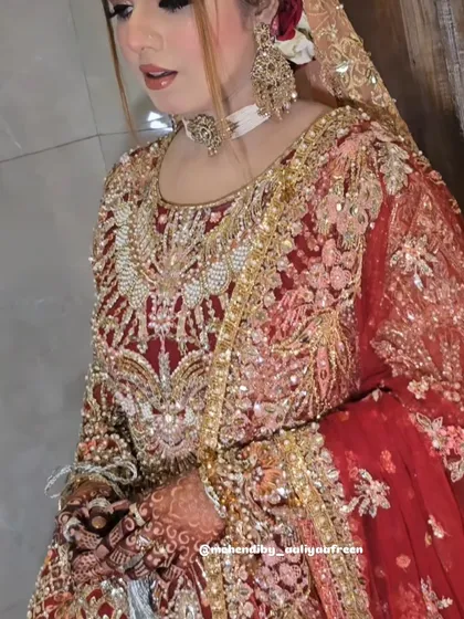 A glimpse of a stunning bride in her full wedding attire, with her intricate mehendi visible.