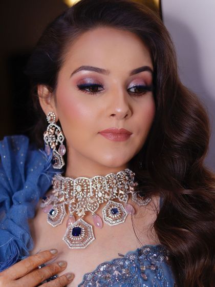 A close-up of this stunning blue-toned eye makeup for a sangeet. The blend of pink and shimmery blue is unique and perfectly complements her statement jewelry.